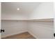 A spacious closet with white walls, wood flooring and a wooden shelf, ready to organize your wardrobe at 7223 N 14Th St, Phoenix, AZ 85020