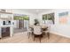 Bright dining area with a round table, seating for six, and sliding doors leading to the backyard at 7223 N 14Th St, Phoenix, AZ 85020
