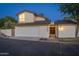 Attractive two-story home with a white garage door, distinctive lighting, and inviting entryway at dusk at 7223 N 14Th St, Phoenix, AZ 85020