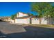 Inviting two-story home featuring a bright white garage door and manicured lawn with mature landscaping at 7223 N 14Th St, Phoenix, AZ 85020