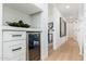 Bright hallway with a beverage fridge, white trim, and light colored flooring at 7223 N 14Th St, Phoenix, AZ 85020