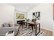 A cozy home office space with a comfortable chair, desk, and natural light from the window at 7223 N 14Th St, Phoenix, AZ 85020