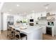 Modern kitchen with white cabinets, island with seating, and stainless steel appliances, perfect for entertaining at 7223 N 14Th St, Phoenix, AZ 85020
