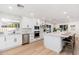 Bright kitchen boasts white cabinets, stainless steel appliances, and a spacious center island with bar seating at 7223 N 14Th St, Phoenix, AZ 85020