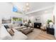 Spacious living room with a cozy fireplace, large windows, and stylish furnishings at 7223 N 14Th St, Phoenix, AZ 85020