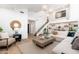Bright and open living room with high ceilings, modern decor, and stairs leading to a loft area at 7223 N 14Th St, Phoenix, AZ 85020