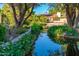 Peaceful view of the pond reflecting the landscape showcasing the community's commitment to natural beauty and serenity at 7223 N 14Th St, Phoenix, AZ 85020