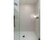 Modern tiled shower featuring a rain shower head, handheld sprayer, and niche for storage at 7223 N 14Th St, Phoenix, AZ 85020