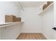 Walk-in closet with wooden clothes rods, shelving, and wicker basket storage; ample space at 7223 N 14Th St, Phoenix, AZ 85020
