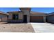 Attractive single-story home with a brown roof, low-maintenance desert landscaping, and an attached two-car garage at 7259 E Blissful Breeze Ln, San Tan Valley, AZ 85143