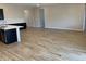 Open-concept living space featuring wood-look tile flooring and neutral walls, creating a bright and airy atmosphere at 7259 E Blissful Breeze Ln, San Tan Valley, AZ 85143