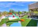 Backyard with a pool, play structure, patio area, and a view of the well landscaped surroundings at 7260 E Tasman St, Mesa, AZ 85207