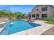 A backyard with a pool, patio area, trampoline, slide, and lounge furniture perfect for fun at 7260 E Tasman St, Mesa, AZ 85207