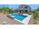 Beautiful backyard including a pool, lounge area, water slide, and seating for outdoor enjoyment at 7260 E Tasman St, Mesa, AZ 85207