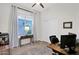 This well-lit bedroom is complete with a large window and includes an organized workstation at 7260 E Tasman St, Mesa, AZ 85207