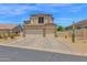Two-story home showcasing a three-car garage and desert landscaping for curb appeal at 7260 E Tasman St, Mesa, AZ 85207