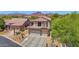 Charming two-story home showcasing desert landscaping and a three-car garage at 7260 E Tasman St, Mesa, AZ 85207