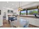 Bright kitchen with island, white cabinets, stainless steel appliances, and adjacent breakfast nook at 7260 E Tasman St, Mesa, AZ 85207