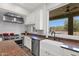 Well-lit kitchen with stainless steel appliances, island, and bright window view at 7260 E Tasman St, Mesa, AZ 85207