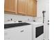 Convenient laundry room featuring updated washer and dryer, plus wooden cabinetry and ample storage space at 7260 E Tasman St, Mesa, AZ 85207