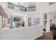 Bright living room with high ceilings, white walls, and an adjacent dining area at 7260 E Tasman St, Mesa, AZ 85207
