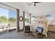 Bright main bedroom boasts neutral tones, a sitting area, and a sliding door to the outside patio at 7260 E Tasman St, Mesa, AZ 85207