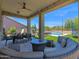 Spacious covered patio with outdoor seating, dining area, and view of the backyard pool at 7260 E Tasman St, Mesa, AZ 85207