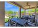 Relaxing covered patio with a seating area and dining table, overlooking the backyard at 7260 E Tasman St, Mesa, AZ 85207