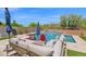Inviting backyard pool with lounge chairs, a waterfall feature, and surrounding landscaping at 7260 E Tasman St, Mesa, AZ 85207