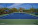 Well-maintained tennis court with blue surface and green surroundings in a landscaped area at 7260 E Tasman St, Mesa, AZ 85207