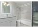 Updated bathroom with modern vanity, shower-tub combo, and tile surround at 8339 W Devonshire Ave, Phoenix, AZ 85037