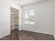 Bedroom with hardwood floors, closet, and bright window creates a comfortable space at 8339 W Devonshire Ave, Phoenix, AZ 85037