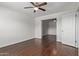Bright bedroom features a ceiling fan, wood floors, and white walls at 8339 W Devonshire Ave, Phoenix, AZ 85037