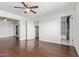 Bedroom featuring hardwood floors and ceiling fan with a view into an adjacent bathroom at 8339 W Devonshire Ave, Phoenix, AZ 85037