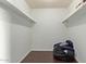 Spacious closet with shelving and hardwood floors provides storage space at 8339 W Devonshire Ave, Phoenix, AZ 85037