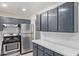 An updated kitchen featuring stainless appliances and gray cabinets at 8339 W Devonshire Ave, Phoenix, AZ 85037