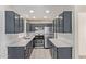 Updated kitchen with gray cabinets, stainless steel appliances, and white countertops at 8339 W Devonshire Ave, Phoenix, AZ 85037