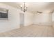 Spacious living room with tile floors and a view of the chandelier at 8339 W Devonshire Ave, Phoenix, AZ 85037