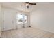 Bright living room with tile flooring, ceiling fan, and natural light at 8339 W Devonshire Ave, Phoenix, AZ 85037