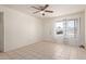 Bright living room with tile flooring, ceiling fan, and natural light at 8339 W Devonshire Ave, Phoenix, AZ 85037