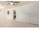 Open living room with tile flooring, ceiling fan, and view into the kitchen at 8339 W Devonshire Ave, Phoenix, AZ 85037
