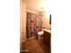 Cozy bathroom featuring tile flooring, a shower with a patterned curtain, and a single sink vanity at 9285 E Sutton Dr, Scottsdale, AZ 85260