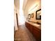 Bright bathroom features a double sink vanity with granite countertop, soaking tub and tiled floors at 9285 E Sutton Dr, Scottsdale, AZ 85260