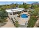 Aerial view of a private desert home with a rock pool and lush landscaping at 9349 E Calle De Valle Dr, Scottsdale, AZ 85255