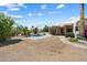 Spacious backyard with a rock-lined pool, stone patio, and a low-maintenance desert landscape at 9349 E Calle De Valle Dr, Scottsdale, AZ 85255