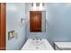 Powder blue bathroom featuring a modern vanity, Kohler sink, and a wood-trimmed mirror at 9349 E Calle De Valle Dr, Scottsdale, AZ 85255