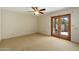 A bedroom features access to the backyard through wood-framed glass doors at 9349 E Calle De Valle Dr, Scottsdale, AZ 85255