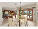 Open dining room showcasing an elegant chandelier, access to outdoor patio, and view into the gourmet kitchen at 9349 E Calle De Valle Dr, Scottsdale, AZ 85255