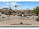 Charming desert home featuring beautiful landscaping, a unique courtyard entrance, and a tile roof at 9349 E Calle De Valle Dr, Scottsdale, AZ 85255