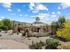 Stunning Santa Fe home showcasing desert landscaping, an elegant courtyard and a striking mountain backdrop at 9349 E Calle De Valle Dr, Scottsdale, AZ 85255